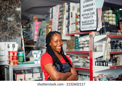 Shot of a cheerful black african millennial woman posing proudly at camera with arm crossed.
