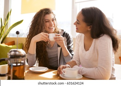 Shot of cheerful girlfriends spending time together at the cafe talking and laughing happily coffee shop tea drinking drink beverage lifestyle meeting friendship teenager communication diversity relax - Powered by Shutterstock