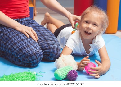 Shot Of A Child Lying On The Floor During An Integration Therapy Session