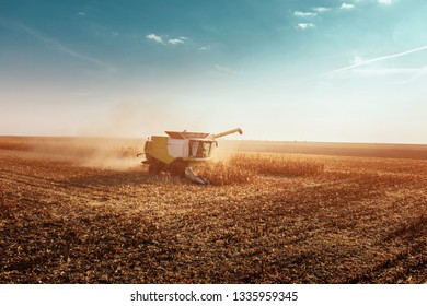 Shot Of A Combine Harvester Working In A Field At Sunset