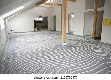 Shot Of Construction Site In A Loft Where Underfloor Heating Has Just Been Installed, White Pipes On Grey Mat