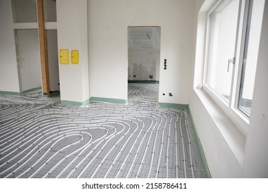 Shot Of Construction Site In A Loft Where Underfloor Heating Has Just Been Installed, White Pipes On Grey Mat