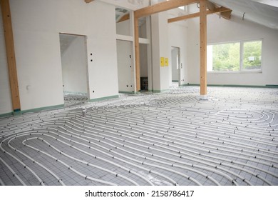 Shot Of Construction Site In A Loft Where Underfloor Heating Has Just Been Installed, White Pipes On Grey Mat