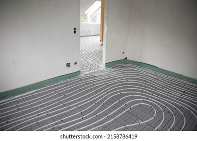 Shot Of Construction Site In A Loft Where Underfloor Heating Has Just Been Installed, White Pipes On Grey Mat