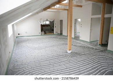 Shot Of Construction Site In A Loft Where Underfloor Heating Has Just Been Installed, White Pipes On Grey Mat