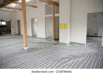 Shot Of Construction Site In A Loft Where Underfloor Heating Has Just Been Installed, White Pipes On Grey Mat