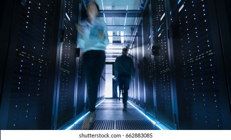 Shot of Corridor in Large Data Center Full of Walking and Working People. Pronounced Motion Blur.