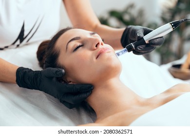 Shot of cosmetologist making mesotherapy injection with dermapen on face for rejuvenation on the spa center. - Shutterstock ID 2080362571