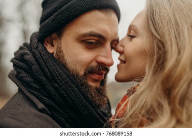 Shot of couple in love standing with their head together. Affectionate young couple in forest. Loving couple hiking in forest. - Shutterstock ID 768089158
