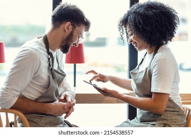 Shot of couple owners bakery working while analyzing report for order delivery with digital tablet in a pastry shop. - Powered by Shutterstock