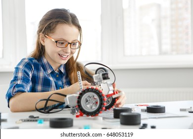 Shot of a cute young girl smiling joyfully building a robot copyspace constructor engineering playing childhood kids hobby leisure lifestyle people toys robotics technology intelligence learning