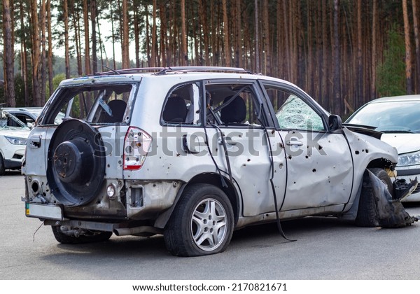 Shot,\
damaged cars during the war in Ukraine. The car of civilians was\
damaged. Shrapnel and bullet holes in the car body. War of Russia\
against Ukraine. Ukraine, Irpen - May 12,\
2022