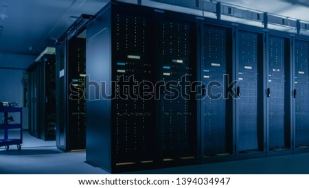 Shot of Data Center With Multiple Rows of Fully Operational Server Racks. Modern Telecommunications, Cloud Computing, Artificial Intelligence, Database, Super Computer Technology Concept.