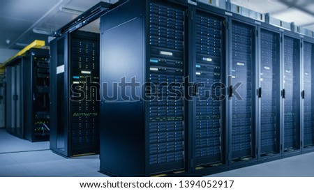 Shot of Data Center With Multiple Rows of Fully Operational Server Racks. Modern Telecommunications, Cloud Computing, Artificial Intelligence, Database, Super Computer Technology Concept.