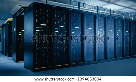 Shot of Data Center With Multiple Rows of Fully Operational Server Racks. Modern Telecommunications, Cloud Computing, Artificial Intelligence, Database, Super Computer Technology Concept.