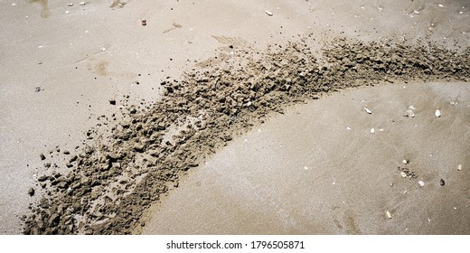 A Shot Of A Dirt Bike Tire Track That Run Along A Sand Beach, Backgrounds / Textures.