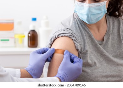 Shot of a doctor applying a bandaid to her patients arm