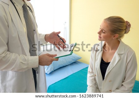 Similar – Doctor giving a prescription to senior patient