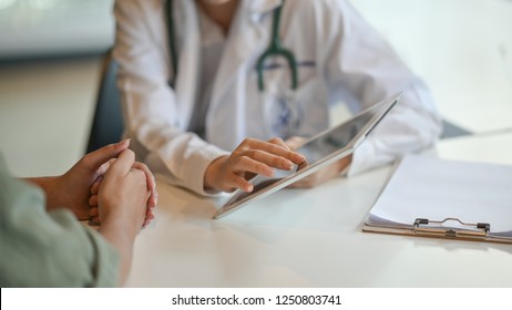 Shot Of A Doctor Showing A Patient Some Information On A Digital Tablet