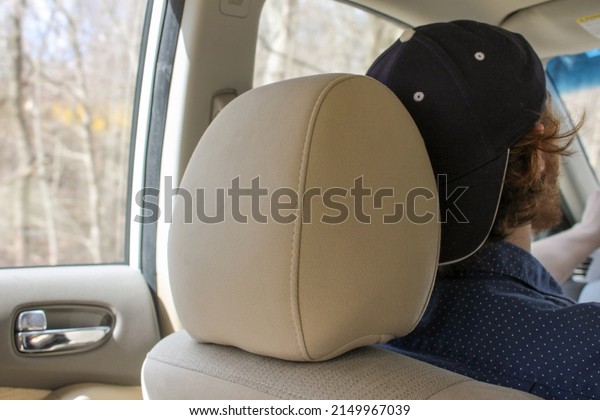 Shot of a driver from the\
backseat.