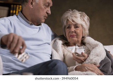 Shot of an elderly couple sitting on a sofa - Shutterstock ID 394960054