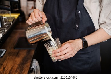 Shot of elderly lady coffee maker pouring milk to cup in coffee bar. - Powered by Shutterstock