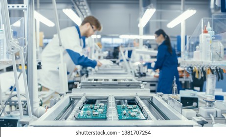 Shot of an Electronics Factory Workers Assembling Circuit Boards by Hand While it Stands on the Assembly Line. High Tech Factory Facility. - Shutterstock ID 1381707254