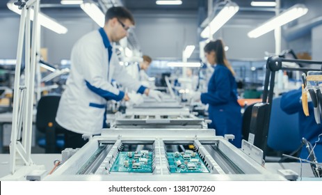 Shot of an Electronics Factory Workers Assembling Circuit Boards by Hand While it Stands on the Assembly Line. High Tech Factory Facility. - Shutterstock ID 1381707260