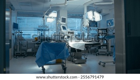 Shot with Empty Operating Room with Advanced Surgical Lights and Modern Medical Equipment and Sterile Preparation for Upcoming Surgical Procedures. Photo Without People in Modern Clinic