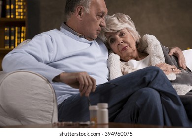Shot of en elderly couple sitting together on a sofa - Shutterstock ID 394960075