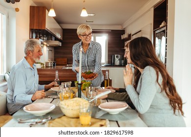 Shot of a family having a meal together indoors - Shutterstock ID 1829617598
