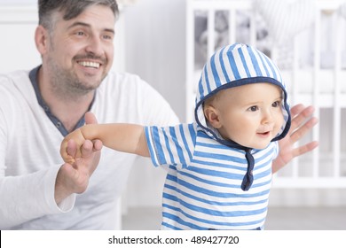 Shot of a father playing with his baby in a nursery room
