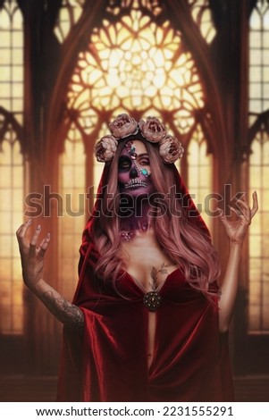 Shot of fearful demon woman with makeup dressed in red cloak and wreath of roses.