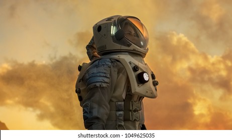 Shot of Female Astronaut in the Space Suit Looking Around Alien Planet. Red and Orange Planet Similar to Mars. Advanced Technologies, Space Travel, Colonization Concept. - Shutterstock ID 1049625035