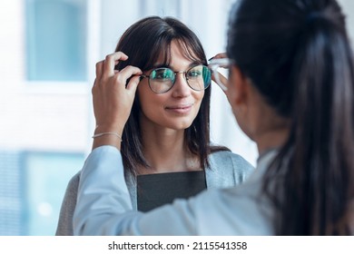 Shot of female doctor choosing while proving eyeglasses to mature beautiful patient in medical consultation. - Powered by Shutterstock