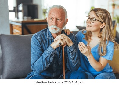 Shot of a female healthcare worker comforting elderly man at home. A woman carer concerned about an elderly man looking depressed. Feeling sad.  - Shutterstock ID 2278101095