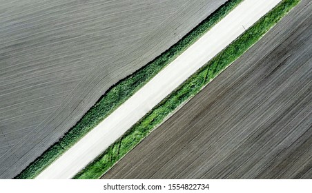 Shot of the field from drone. Farmers field. Road between fields. Background or texture