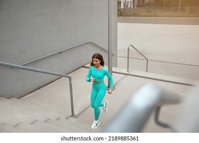 Shot Of Fitness Woman Running Up On Steps. Female Runner Athlete Going Up Stairs