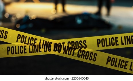 Shot Focused on Yellow Tape Showing Text "Police Line Do Not Cross". Tape Used to Restrict a Crime Scene Where Forensics, Detectives and Policemen are Working on Solving a Homicide Case - Shutterstock ID 2230640045