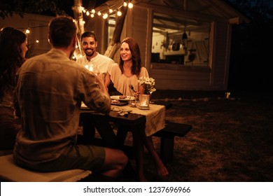 Shot Of Friends Having Fun At A Dinner Party In A Backyard