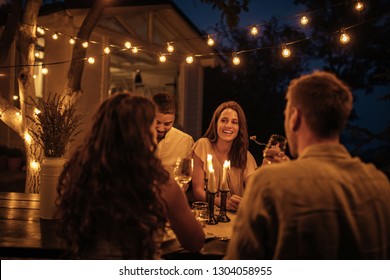 Shot of friends having fun at a dinner party in a backyard - Shutterstock ID 1304058955