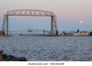 A Shot of the Full Moon Rising behind the Iconic Duluth Aerial Lift Bridge with a Clear Belt of Venus Twilight Sky
