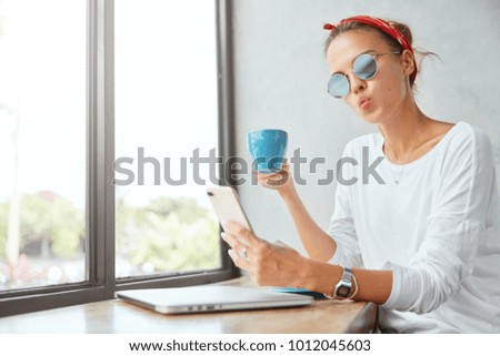 Similar – Image, Stock Photo Hand holding coffee, woman drinking in background