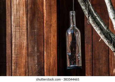 A Shot Of A Glass Bottle Used As A Candle Holder.