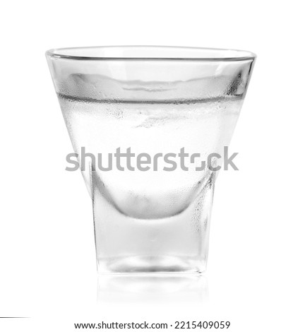 Shot glass of vodka on white background. Alcoholic drink