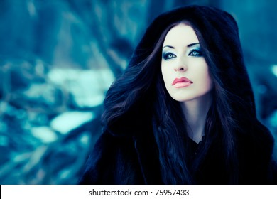 Shot of a gothic woman in a winter park. Fashion.