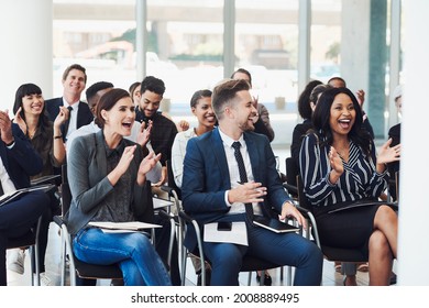 Shot of a group of businesspeople clapping during a conference - Shutterstock ID 2008889495