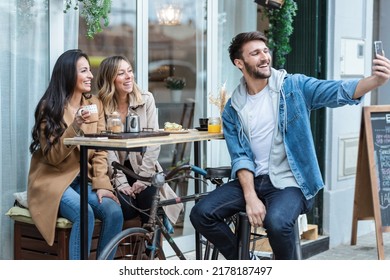 Shot Of Group Of Cool Friends Sharing A Brunch Together While Taking A Selfie With Smartphone On The Healthy Coffee Shop Terrace.