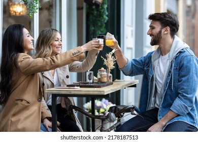 Shot Of Group Of Cool Friends Sharing A Brunch Together While Toasting Their Beverages On The Healthy Coffee Shop Terrace.