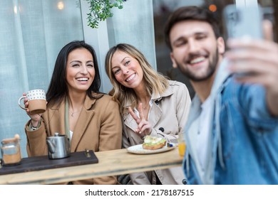 Shot Of Group Of Cool Friends Sharing A Brunch Together While Taking A Selfie With Smartphone On The Healthy Coffee Shop Terrace.